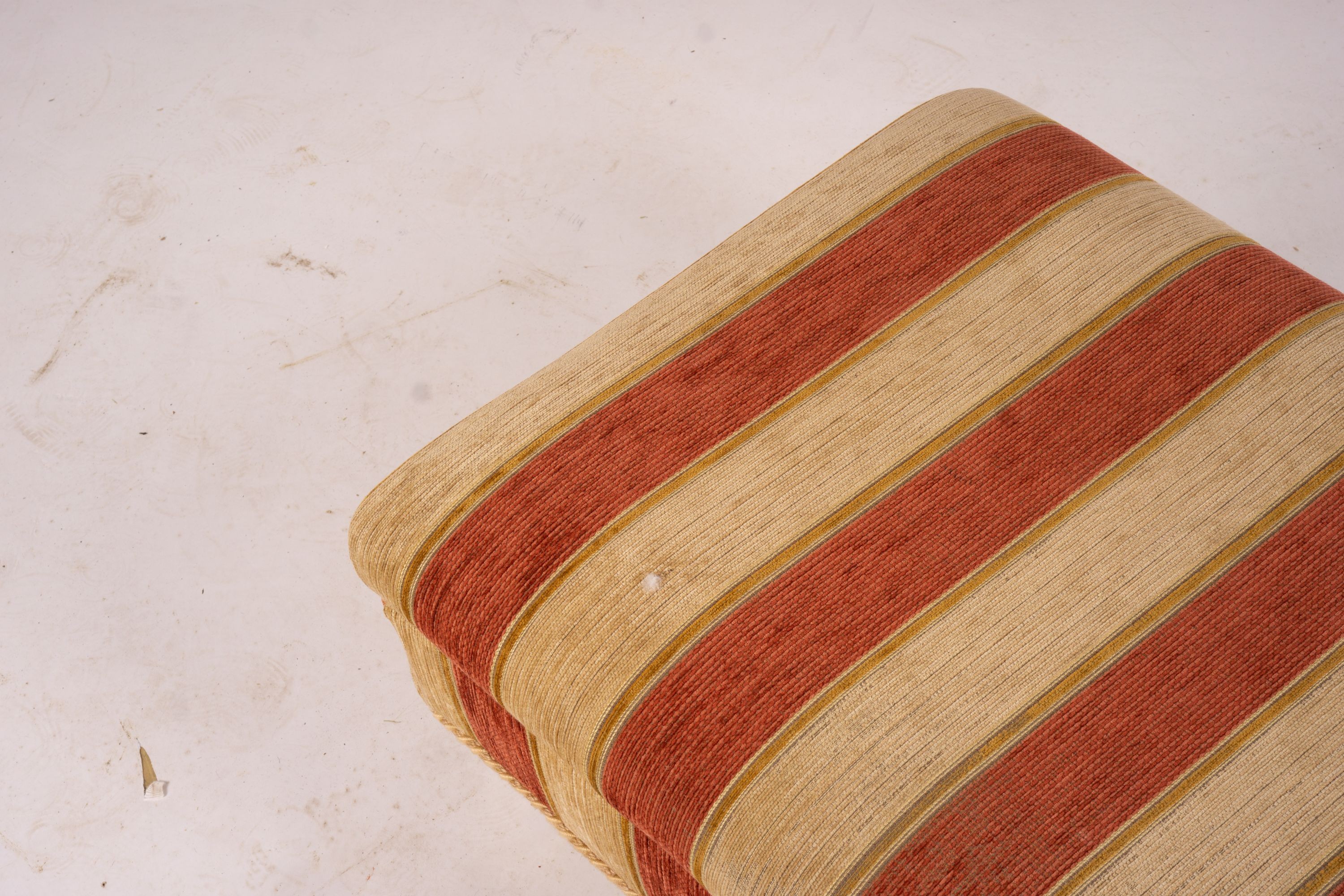 A pair of Duresta armchairs, width 94cm, depth 90cm, height 90cm and matching footstool in striped red and gold fabric